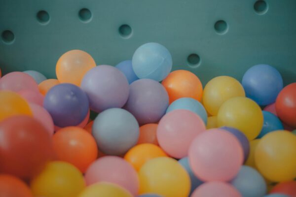 A close-up view of a colorful assortment of plastic balls in a ball pit, showcasing vibrant hues.